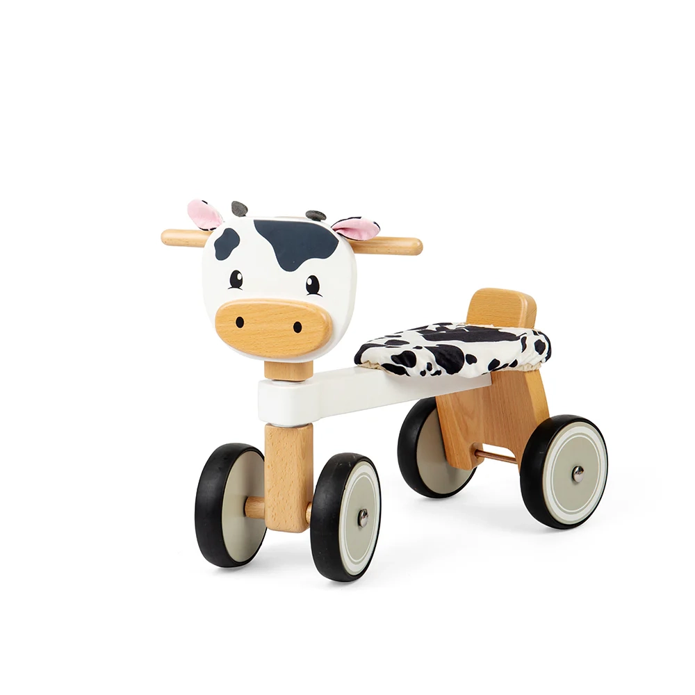 This adorable Bigjigs Ride On Cow features four chunky wheels, sturdy wooden handlebars, and a fluffy seat for added comfort!