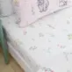 This Bunny Tails Ditsy Flowers Toddler Fitted Sheet, from Catherine Lansfield features a pretty floral design on a white background.