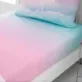 This Ombre Rainbow Clouds Single Fitted Sheet by Catherine Lansfield features a beautiful cosmic ombré design in pastel colours.