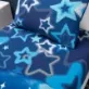 This Ombre Stars Blue Single Fitted Sheet by Catherine Lansfield features featuring a stunning cosmic ombré design in deep blue.