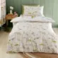 Sleepy Dino Toddler Duvet Cover Set is a fully reversible bedding set, featuring a variety of friendly dinosaurs roaming through a prehistoric landscape.