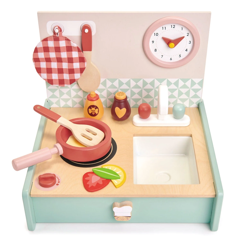 The Tender Leaf Toys Portable Kitchenette is a portable fold away wooden play kitchen with hob and clacking dial. and a pretty clock with moving hands.